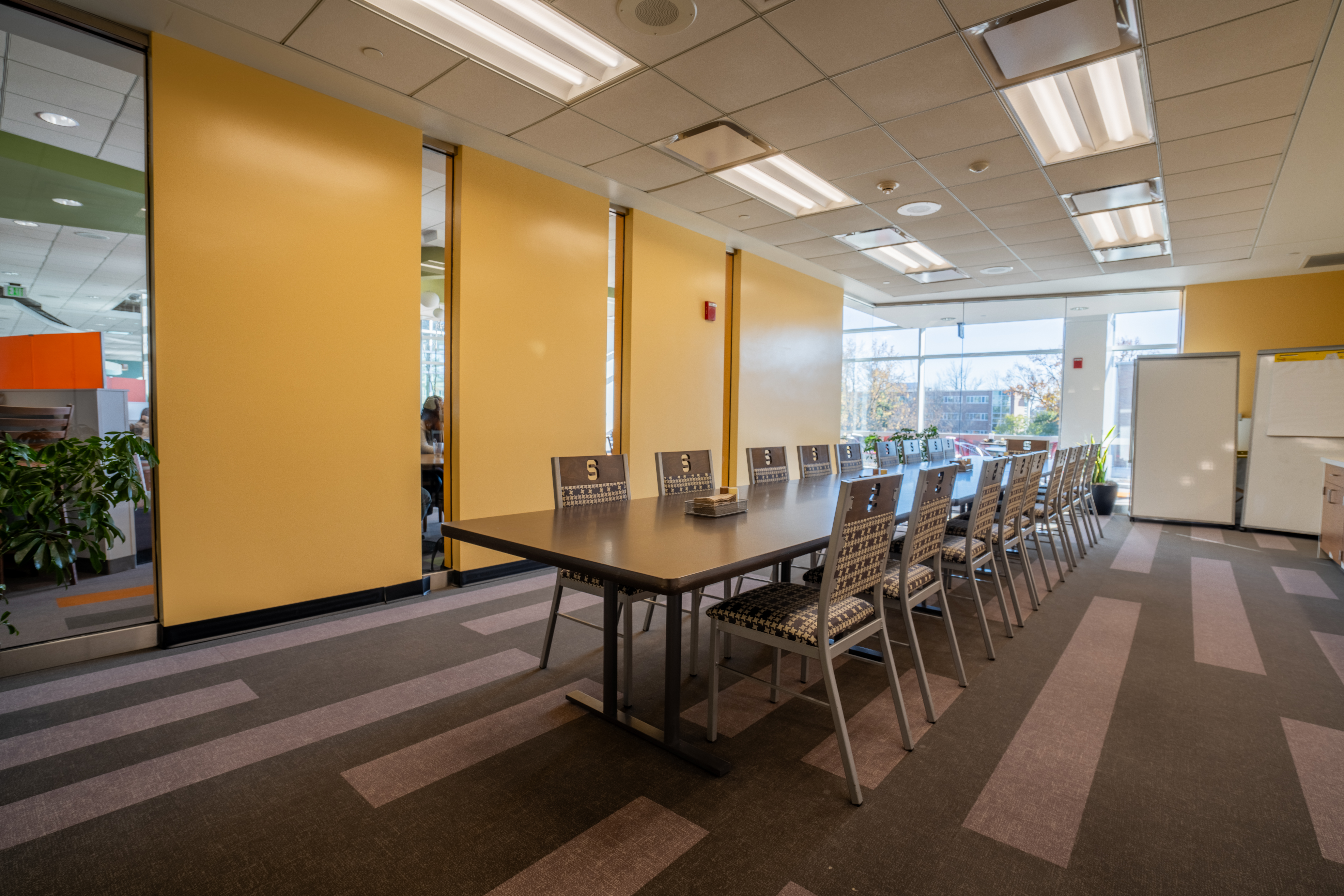 room with long tables and chairs, natural light