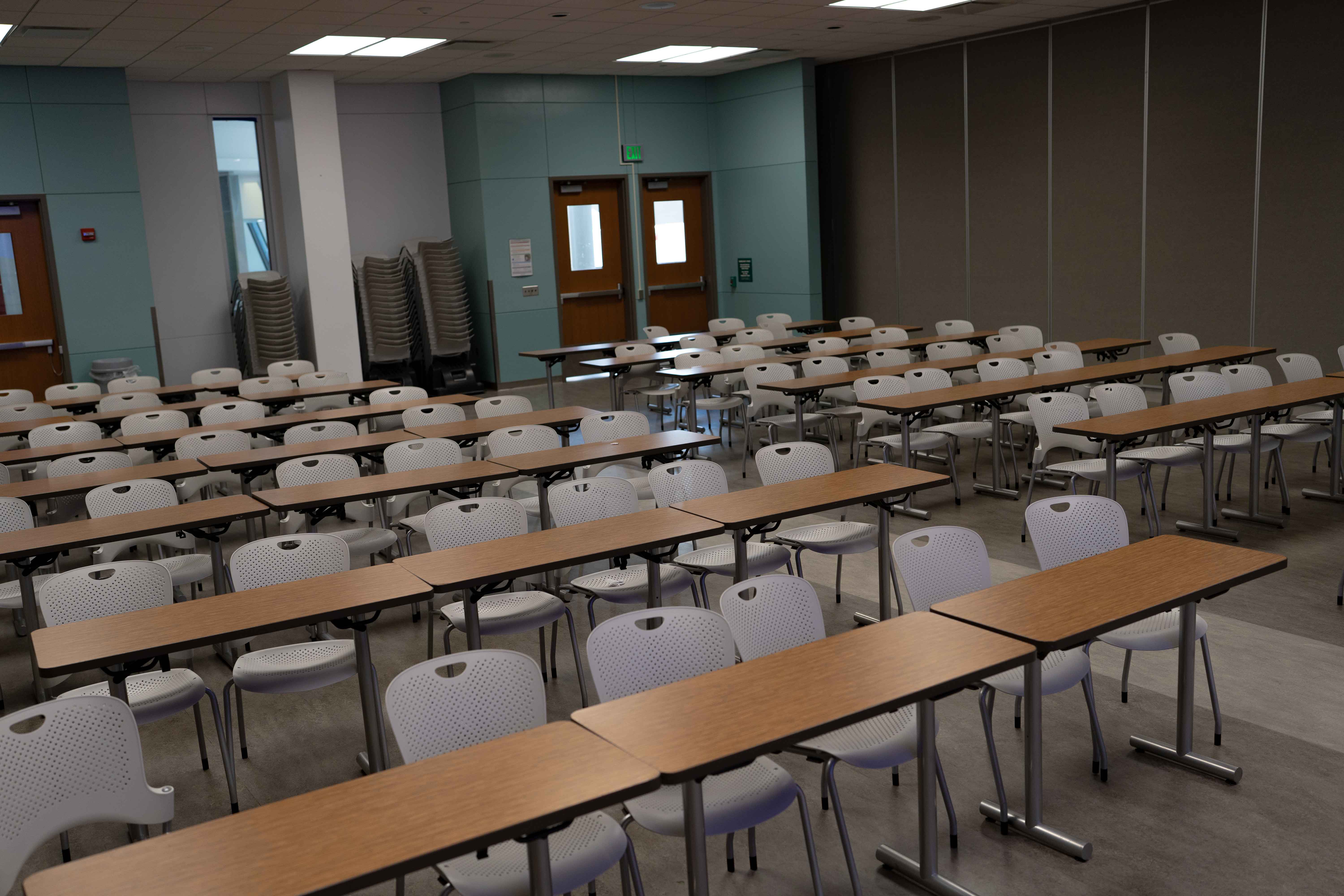 room with long tables and chairs, natural light