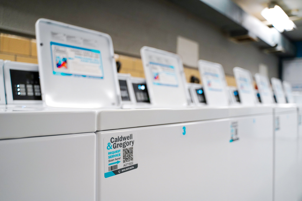 Open washing machines from Caldwell & Gregory in a laundry room