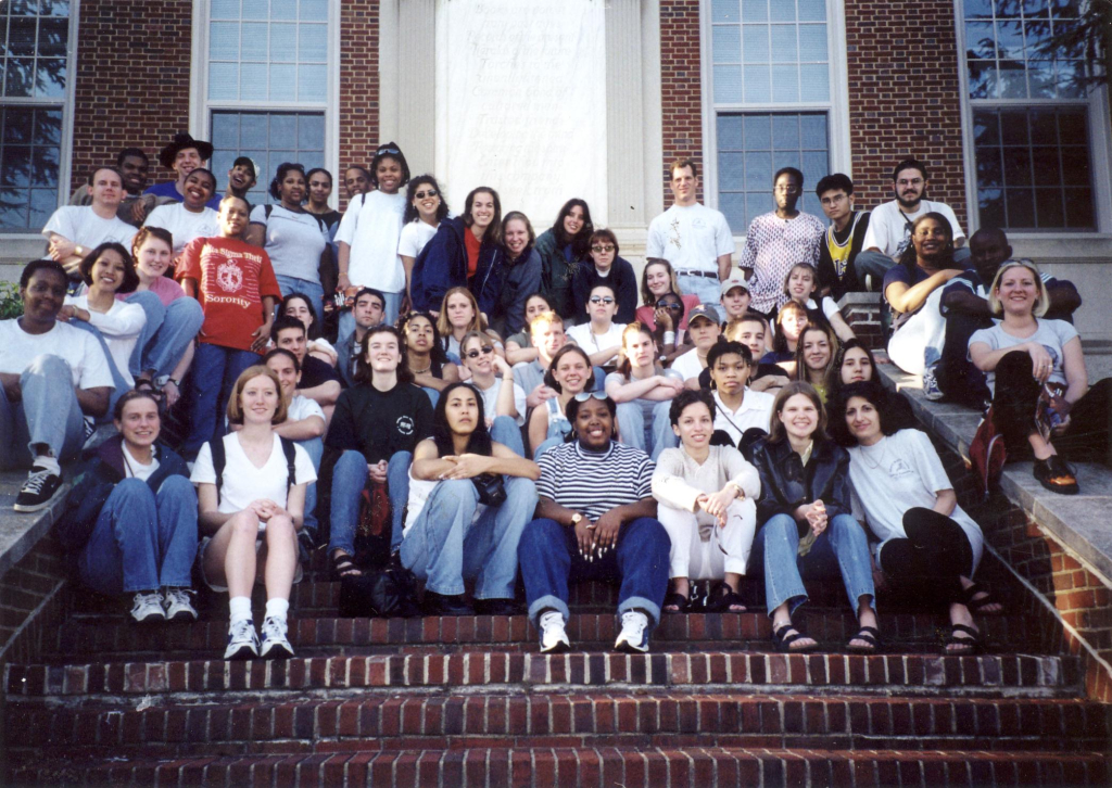 1996 photo of group of MRULE participants sitting on brick, outdoor stairs, looking at the camea.